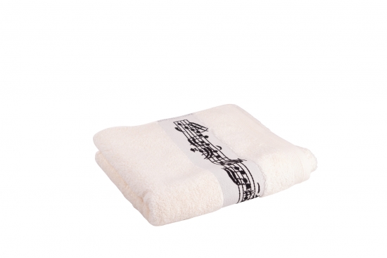 Cream-colored towel with woven music border and clef in the middle